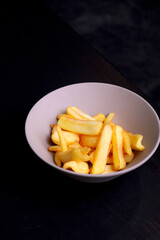 Table scene of assorted take out or delivery foods. Hamburgers, pizza, fried chicken and sides. Top down view on a dark wood banner background.
