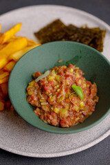Table scene of assorted take out or delivery foods. Hamburgers, pizza, fried chicken and sides. Top down view on a dark wood banner background.