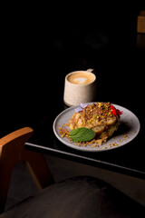 Table scene of assorted take out or delivery foods. Hamburgers, pizza, fried chicken and sides. Top down view on a dark wood banner background.