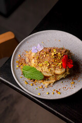 Table scene of assorted take out or delivery foods. Hamburgers, pizza, fried chicken and sides. Top down view on a dark wood banner background.
