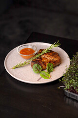 Table scene of assorted take out or delivery foods. Hamburgers, pizza, fried chicken and sides. Top down view on a dark wood banner background.