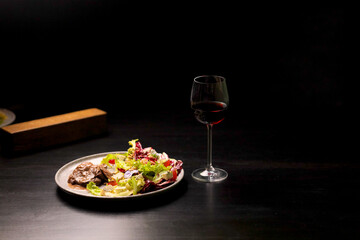 Table scene of assorted take out or delivery foods. Hamburgers, pizza, fried chicken and sides. Top down view on a dark wood banner background.