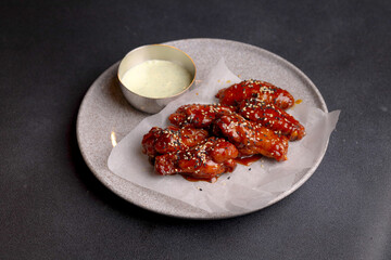 Table scene of assorted take out or delivery foods. Hamburgers, pizza, fried chicken and sides. Top down view on a dark wood banner background.