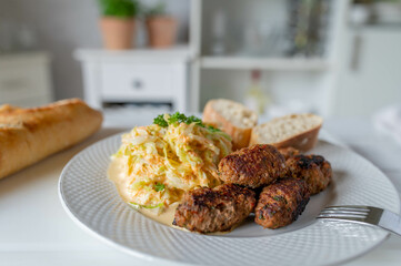 Cevapcici with coleslaw on kitchen counter. Fresh homemade food