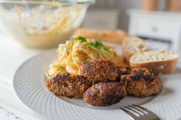 Cevapcici with coleslaw on kitchen counter. Fresh homemade food
