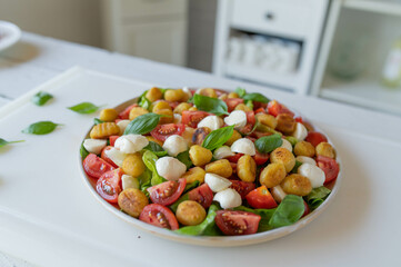 Caprese Salad with tomatoes, mozzarella, fried gnocchi and basil