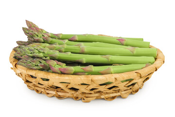 fresh asparagus in in a wicker basket isolated on white background