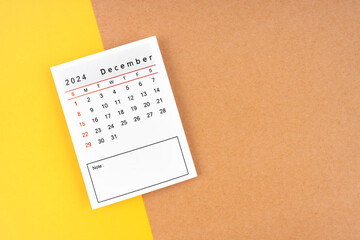 Calendar page for December 2024 on a yellow and brown.