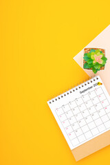 Calendar page for September 2024 and houseplant on yellow background.