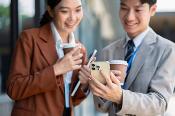 Business team reviewing and discussing a business project outside office building.