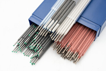 Various colorful welding electrodes/ rods on white background for Industrial and metalworking applications. For welding applications and work. Close- up.
