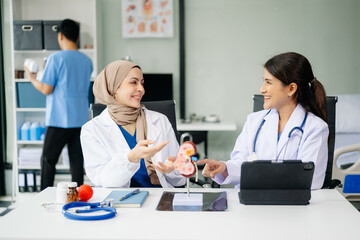Doctor Talks With Professional Head Nurse or Surgeon, They Use Digital tablet Computer. Diverse Team of Health Care Specialists