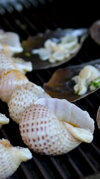 food shellfish. Mussels in a bowl with herbs, rotating on a turntable. Shellfish, seafood close-up