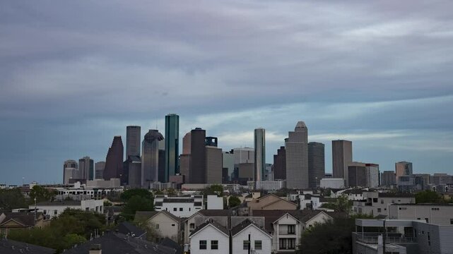 Timelapse of Houston's skyline under shifting clouds, capturing the city's dynamic energy and urban sprawl in a mesmerizing play of light and shadow. Day to Night.