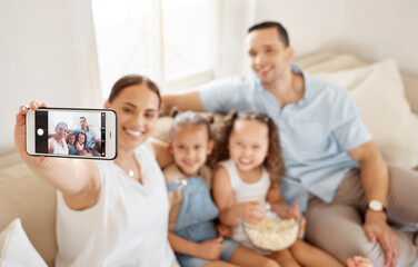 People, family and happy with selfie in sofa at home for fun, bonding and support for memories. Parents, mom and dad with kids in couch with popcorn for profile picture or social media with smile