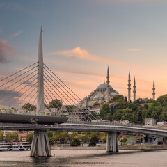 Sunset shot of Golden Horn Metro Bridge, or Halic Bridge, overlapping Suleymaniye Mosque, Istanbul, Turkey