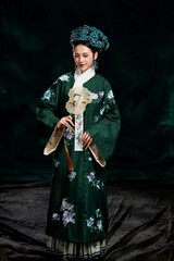 Fototapeta premium Asian,woman,showing,court,costumes,of,the,Qing,Dynasty,in,China