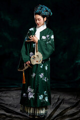 Fototapeta premium Asian,woman,showing,court,costumes,of,the,Qing,Dynasty,in,China