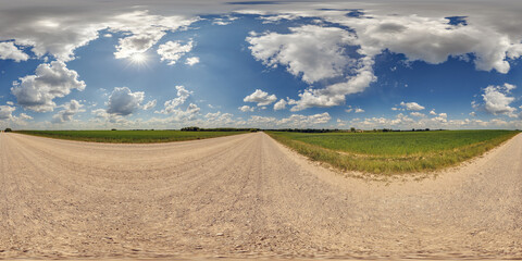 blue sky hdri 360 panorama with awesome clouds on gravel road among fields in spring day in equirectangular full seamless spherical projection, for VR AR content or skydome replacement