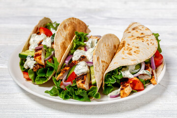 grilled chicken street tacos on a white plate