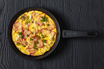 deli ham onion omelette on skillet, top view