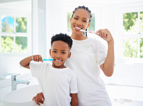 Happy, portrait and mom or boy with toothbrush for dental health, daily routine and gum wellness. Black family, brushing and teeth in bathroom or home for oral hygiene care, cavity and fresh breath.