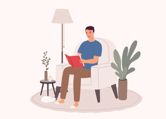 One Smiling Man Sitting On Couch Reading A Book At Home.
