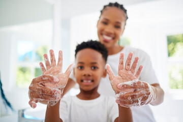Black mom, boy and smile for hands with soap in home for hygiene, care and support with child development. Parent, kid and happy or excited on portrait with handwashing for germs and bacteria