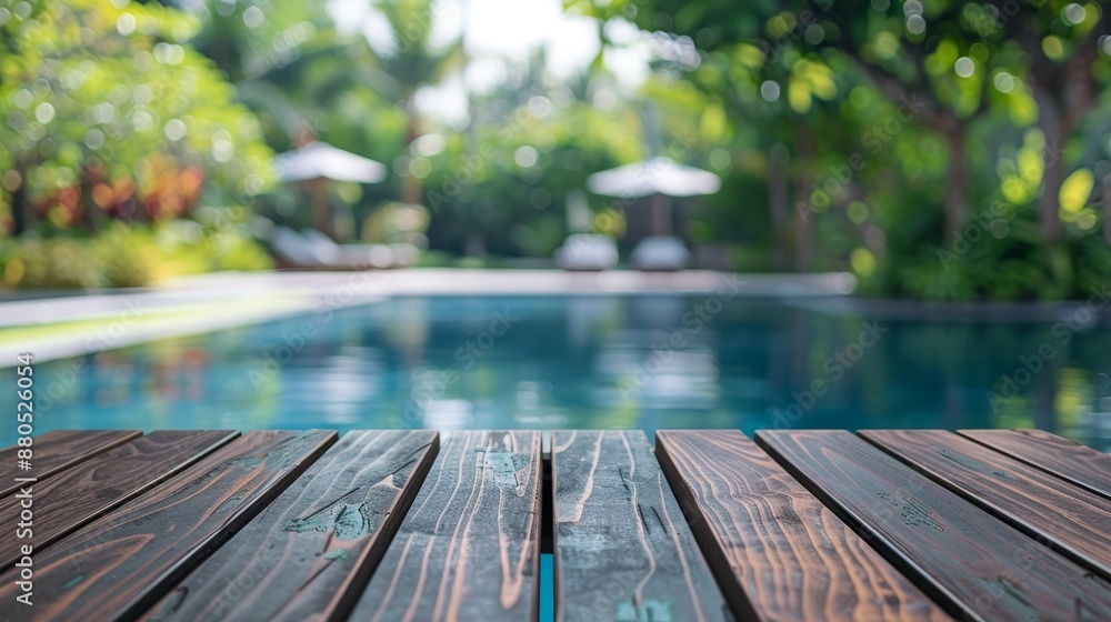 Sticker An empty wooden table with a blurred pool background is shown in front of the picture