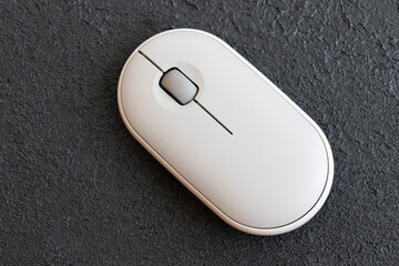 Computer mouse and laptop on desk with blue insulation.