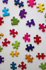 Colorful jigsaw puzzle pieces on white background. Flat lay.
