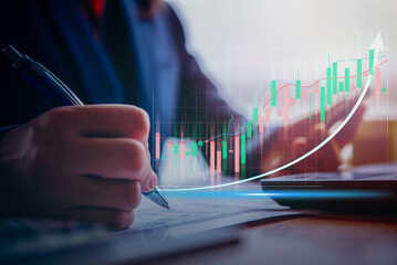 double exposure of businessman using laptop at office with financial info graph show rising , financial and investment concept	
