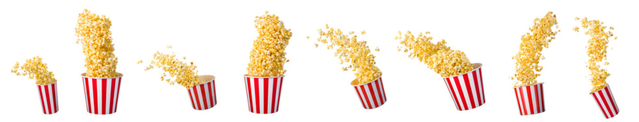 Flying popcorn from paper striped bucket isolated on black background