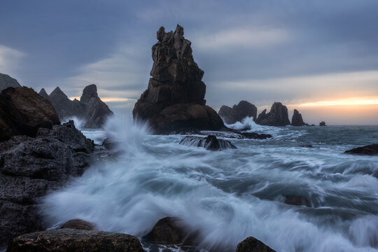 Waves crashing at Costa Quebrada cliffs during sunrise