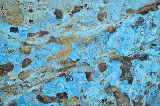 Coastal rock textures with unique blue hues and erosion patterns
