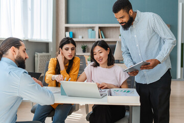 Diverse group of businesspeople working together on a project in the office