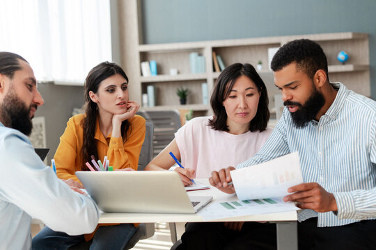 Marketing team analyzing financial data and brainstorming on project