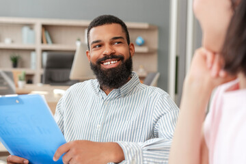 African American professional smiling during job interview with recruiter