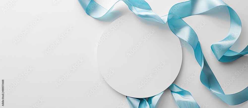 Aufkleber An overhead perspective of a vacant white circle adorned with a soft blue ribbon on a bright isolated backdrop perfect for adding text or images. copy space available