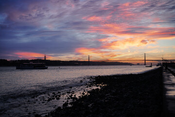 Sunset on Tagus river in Lisbon. View on the Bridge