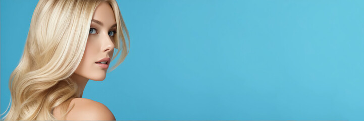 Naklejka premium Flawless blonde with an elegant hairstyle of long hair on blue background with copy space.