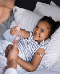 Smile, child and thumbs up for vaccine injection with doctor, thank you and safety success of...