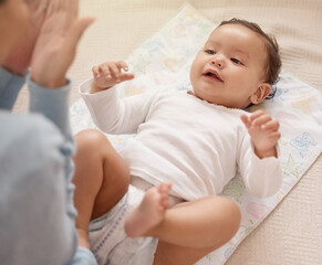 Cheerful baby, mother and care for diaper change with playing, home and nursery for child...