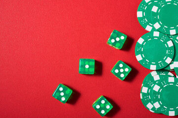 Close-up of a green dices on a red table