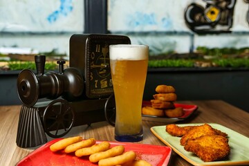 Beer and Snacks on a Table With a Clock