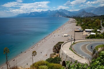 Konyaalti Beach with a seaside mountain range in the background on a sunny day in Antalya, Turkey