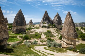 Scenic view of unique rock formations in Cappadocia under a clear blue sky on a sunny day, Turkey