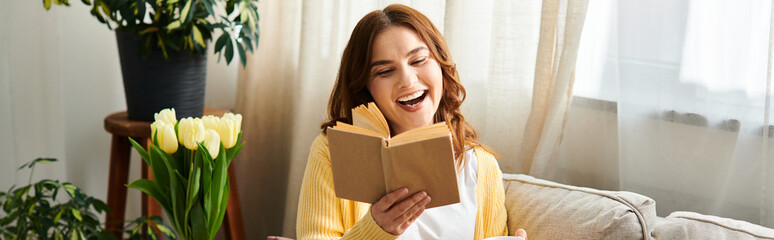 Middle aged woman engrossed in book on cozy couch.