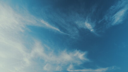 Cloud nature background. Blue sky with clouds and sun. Nature background of airy cloudscape.