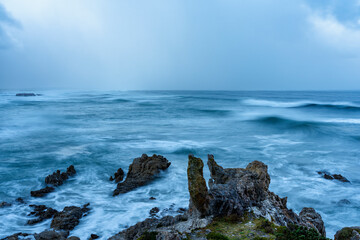 Wild, winter storm conditions at Kwaaiwater with ocean waves breaking onto the rocky Hermanus coastline. Whale Coast, Overberg, Western Cape, South Africa.
